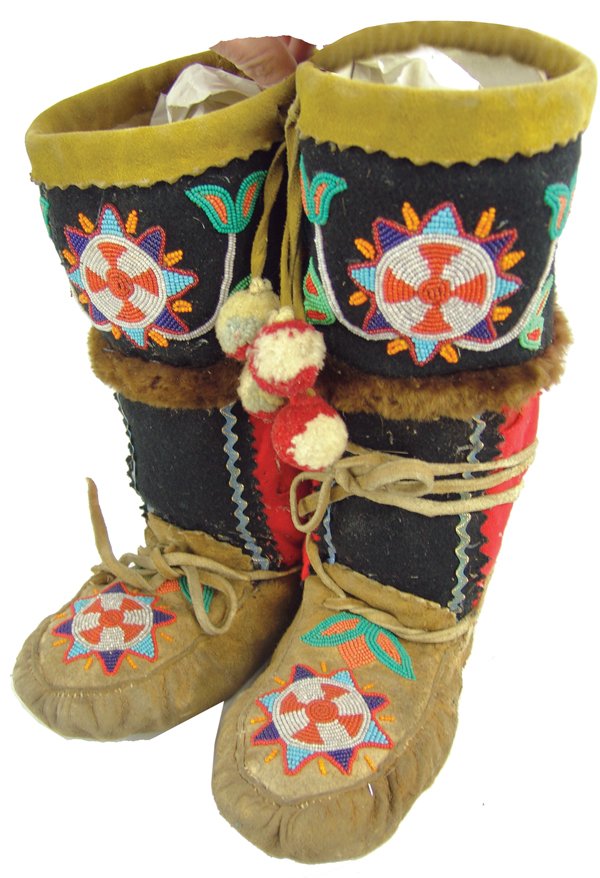 Cree Beaded Mukluks: Tall pair of traditional moose hide high top moccasin boots with beaded florals and rosettes, woolen bodies, fur trim, and puckered toes. Good condition, with wool erosion in several areas.Ca. 1920s11