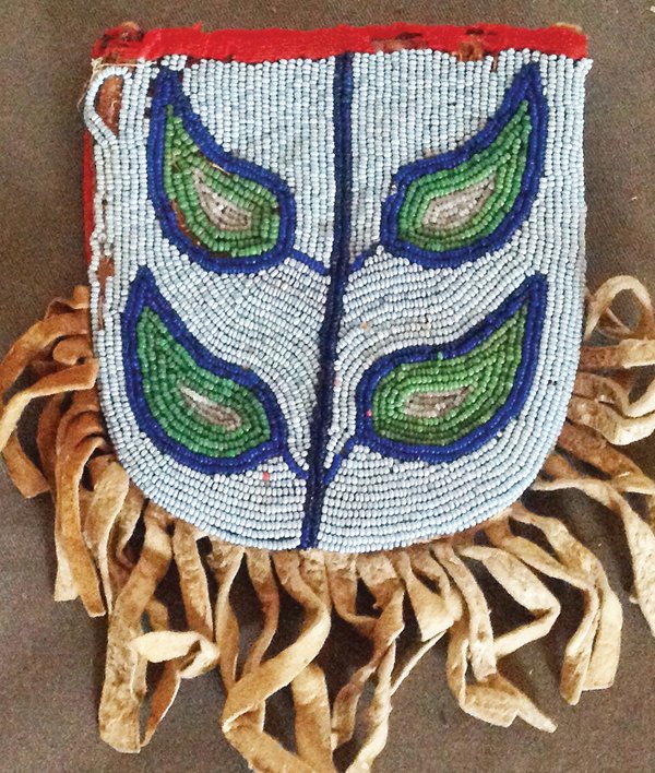 Yakima Beaded Bag: Rare, early, contour beaded pouch with buckskin fringe and contour beaded front. Good condition, minor bead loss/damage. From White Swan. 4-1/2" x 4" Early 1900s