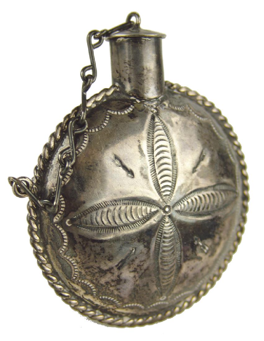 Navajo Silver Canteen: Vintage, handwrought, all silver snuff container with attached cap, and the same stamped designs on both sides. Very good condition, some patina.Ca. 1970s3" x 2-3/4"
