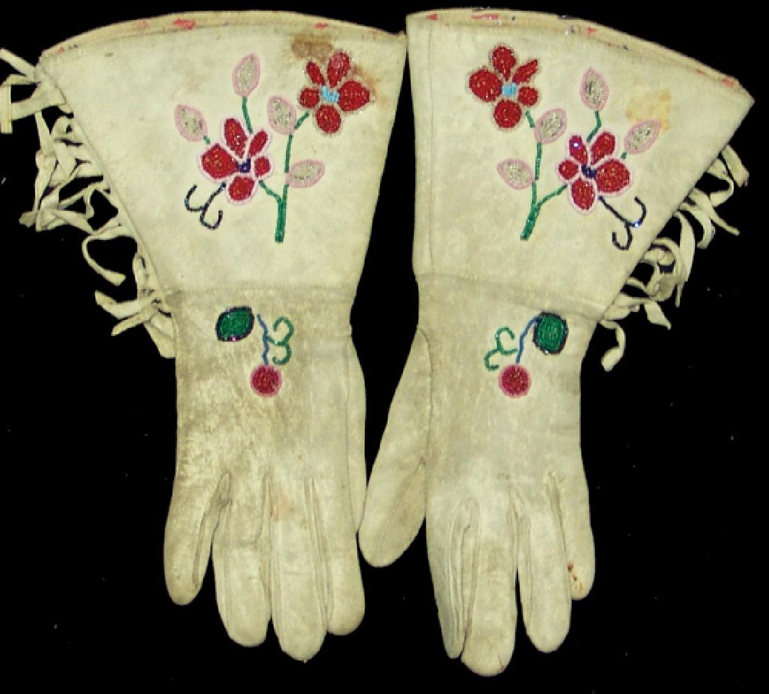 Plateau Beaded Gauntlets: Finer pair of ladies white buckskin gloves with simple floral beadwork on the backhands and cuffs. Good condition.Ca. 1940s13"