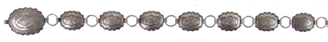 Vintage Navajo Concho Belt: Classic, older, stamped all silver ladies fully adjustable concho belt done in oval rosettes. Fits 1" belt loops. Very good condition, nice patina.Ca. 1950sFits up to 36"