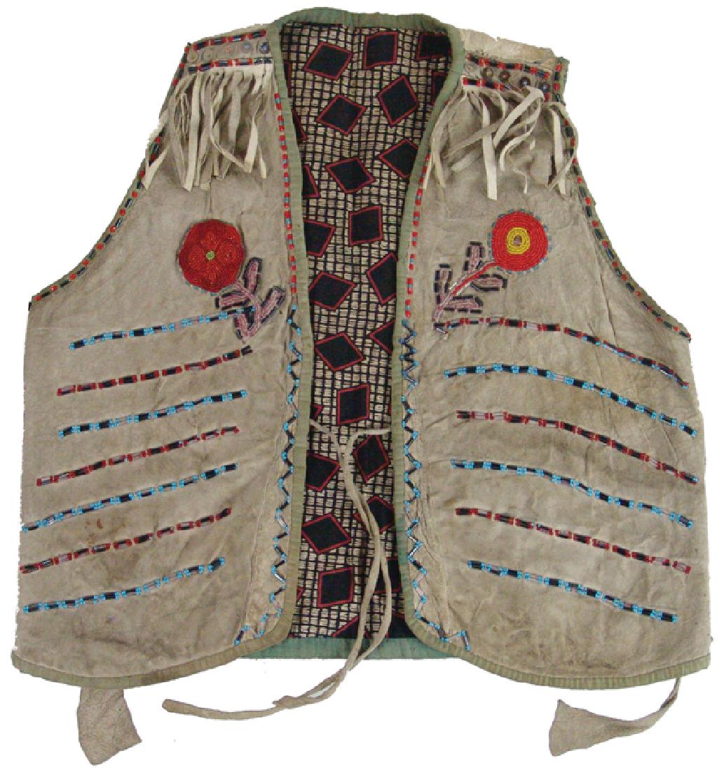 Cree Beaded Child's Vest: Traditional, hand crafted boys buckskin vest with beaded florals and bars, cloth trim, silk lining, and edge fringe. Very good condition.Early/Mid 1900s19" x 19"