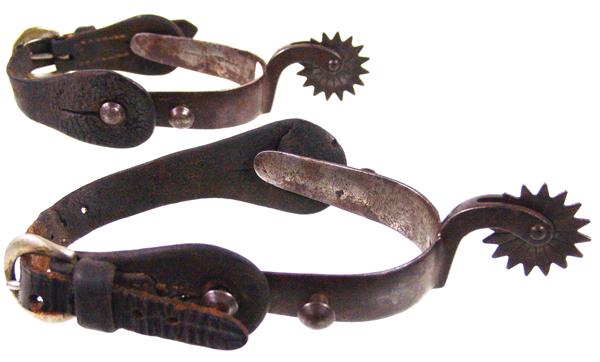 Antique Western Spurs: Early/Mid 1900s Standard Unique pair of cast steel spurs with well used leathers, and 1-1/2", 16-point stamped rowels. Good condition.