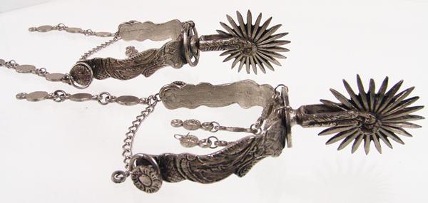 Antique Argentine Gaucho Spurs: Early 1900s Standard Ornately engraved, fancy cowboy spurs with double portrait buttons for leathers/chains, the 3", 24-point rowels sandwiched between engraved discs. Also engraved on the
