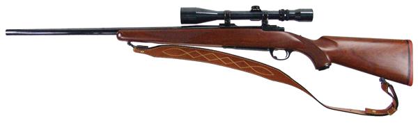 Ruger M77 Rifle with Scope: Mid/Late 1900s 44" Fine, .22-250 cal. bolt action rifle with blued, 24" bull barrel, hand checkered walnut stock, and Weaver V9II stock. Includes heavy leather sling. Very good condition, very