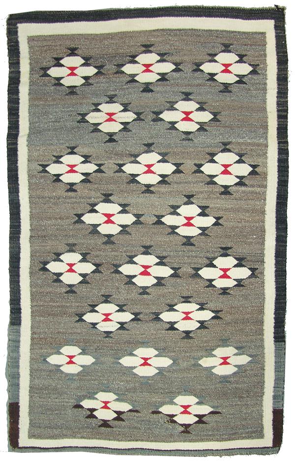 Navajo Rug/Weaving: Mid 1900s 39" x 62" Vintage, homespun all wool rug with black and white border and repeating, serrated diamond forms. Good condition, both sides faded.