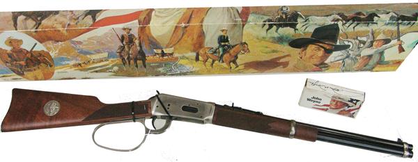 John Wayne Winchester Carbine: Ca. 1980s 18-1/2" barrelLimited edition, .32-40 cal. Model 94, large ring lever action "John Wayne Commemorative" saddle ring carbin, expertly engraved showing "The Duke" on horseback on one side of t