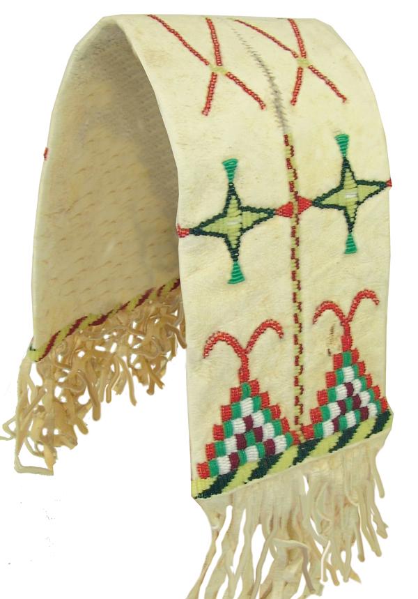 Apache Canine Saddle Bags: Mid 1900s 22" Rare, smaller sized buckskin slit bag with beaded designs over the surface, cut-out suspensions, and buckskin fringe. Very good condition. **These are from the private display collection