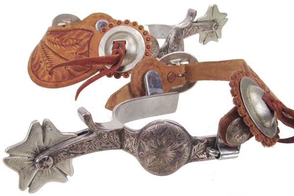 Crockett Western Spurs: Early/Mid 1900s Adult Beautiful, single mounted "ST" spurs with beautiful engraving, tooled leathers with German silver conchos, and with 2", 10-point, clover shaped rowels. Very good condition.