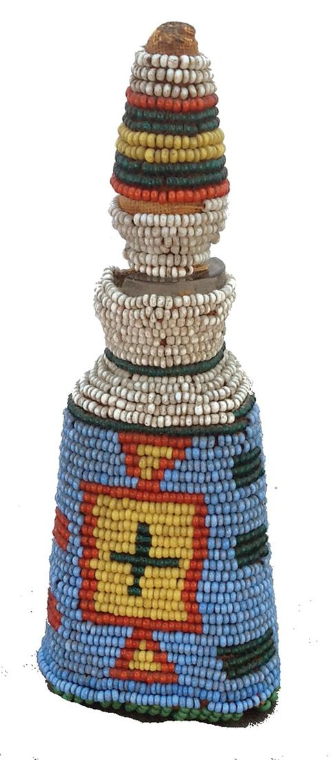 Paiute Beaded Bottle: Early 1900s 4-1/2" x 1-7/8" x 1-1/4" Rare, antique glass holy water bottle with stoppe, fully beaded on the exterior, the design having three different crosses in it. Good condition, a few missing bea