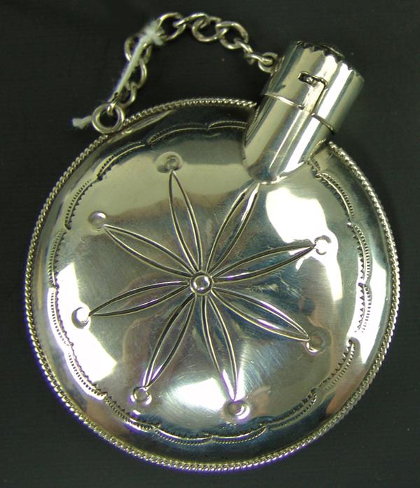 Navajo Silver Canteen: Ca. 1980s 3-1/2" x 3" Quality, handwrought all silver canteen with unique, plains style design, pinched rope work edging, and locking rosette cap. Very good condition, unsigned.