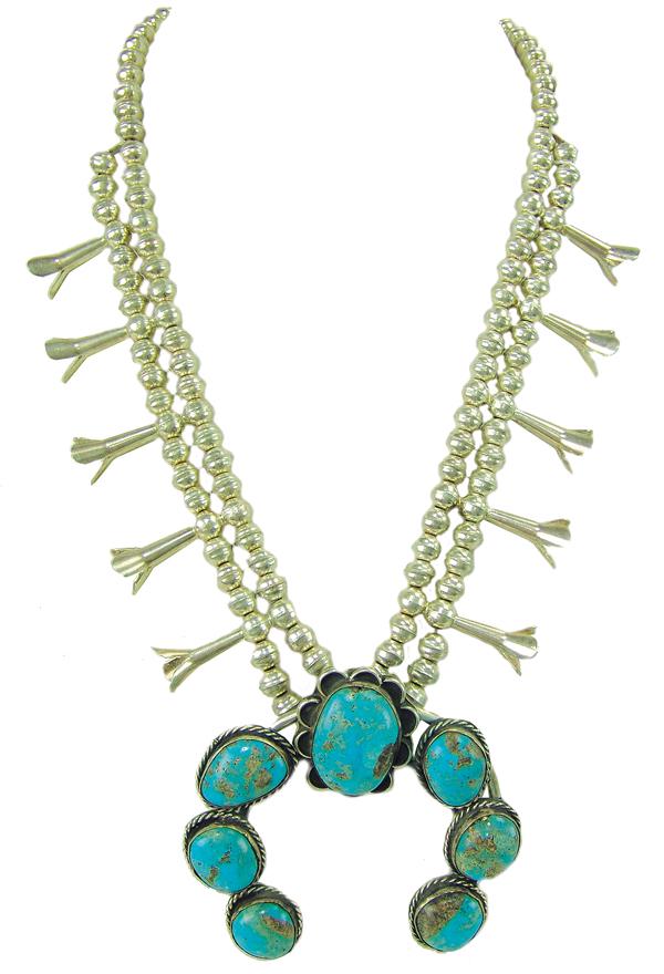 Navajo Squash Blossom Necklace: Ca. 1980s 24", 4" x 3-1/2" pendant Traditional turquoise and silver necklace with classic horseshoe naja contains 7, matching fox stones, the all silver top with 10 "blossoms". Very good condition.
