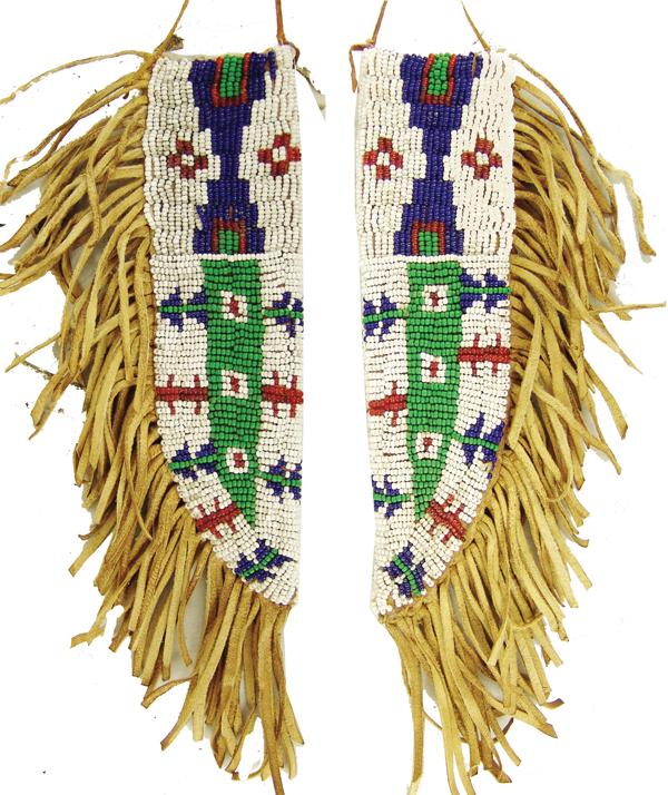 Plains Beaded Knife Sheath: Mid 1900s 6-3/4" Classic, sinew sewn and lazy stitch beaded, two-sided buckskin knife holder with striking, geometric design, plus fine fringe. Very good condition. (both sides shown in photo)