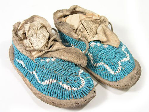 Sioux Moccasins: Unique, 2-color, fully beaded, child's hard soled shoes done with lazy stitch and sinew sewn seed beads. 6" long Circa 1890
