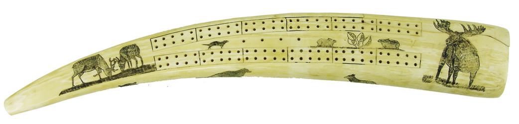 Eskimo Cribbage Board: Impressive, larger sized, vintage, carved and polished walrus tusk, artistically covered with lavish, etched and inked scrimshaw figures including a pair of caribou, large moose, two hares, and a marm
