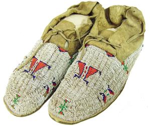 Lakota Sioux Beaded Moccasins: Beautiful, early pair of sinew sewn and lazy stitch beaded moccasins with hard, rawhide soles, classic geometric designs, and wonderful patina. Very good condition overall with some bead loss and seam