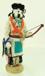 Zuni Kachina Figure - Ben Seciwa: Traditional, hand carved and painted, cottonwood root "Sai Ya Taca" (Long Horn) doll with bow, and turquoise jewelry. Good condition, some missing/damaged parts. Ca. 1980s. 12"