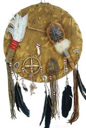 Leather Dance Shield: Interesting, handcrafted, decorative wall shield loaded with accoutrements including a feather fan, turtle shell rattle, buffalo tooth, medicine wheel, feathers, a fetish, and other items. Very good c