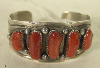 Navajo Coral & Silver Bracelet: M. Dayea, Classic design sterling cuff bracelet set with 5 natural shaped red coral stones. Condition: very good, light use. Circa late 1900s. 5-3/8" + 7/8" gap x 1-1/8" wide