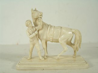 Carved Ivory Figure: Very finely carved sculpture showing a Bavarian (European?) man and a large horse. Condition: very good. Circa mid 1900s. 3-3/4" x 4-1/4" x 2-1/8"