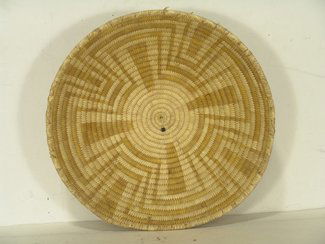 Papago Basket: Fine and large woven wide basketry bowl with geometric maze design done in yellow. Condition: very good, a few broken missing stitches. Circa 1970s. 15" diameter x 4 1/2" high