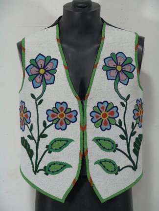 Flathead Beaded Vest: Beautiful white background vest with fully beaded front panels containing vivid floral designs. Condition: very good. Circa 1950. 24" x 22"