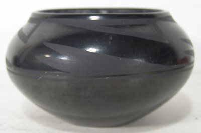 San Ildefonso Pottery Jar: Desideria Montoya Sanchez. Beautiful black on black wide bowl with curled rim and avian wing motif. Signed "Desideria". Condition: Very good, some light scratches. Circa 1960s. 4-1/4" high x 7" diamet