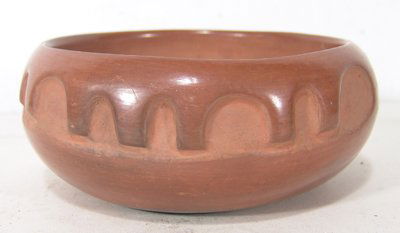 San Ildefonso Pottery Bowl: Juanita Wo-Peen. Beautiful deep carved redware bowl with unique design. Condition: Very good, some light scratches and handling. Circa mid 1900s. 3" high x 7" diameter