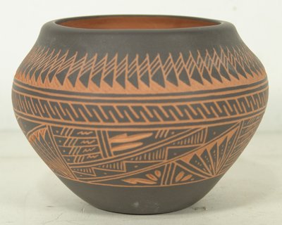 Acoma Pottery Jar: Beautiful incised sgraffito redware jar with intricate feathers and geometric designs. Condition: Like new. Circa late 1900s. 4-1/2" high x 5-3/4" diameter