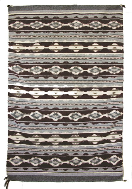 Navajo Weaving: Great Wide Ruins rug with white and gray chevron motif on gray and wine ground, of natural and aniline colors. 5'7" x 3'5" Circa 1960s