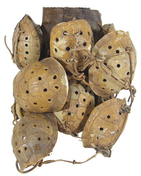 Cherokee Leg Rattles: Very rare single boot leather legging with attached snapping turtle shells made into rattles - produces loud rattle sound; good condition. 17" x 11" Circa Early 1900s