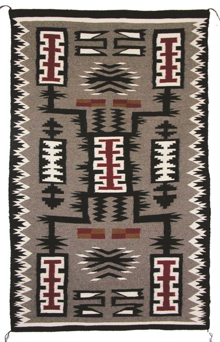 Navajo Weaving: Marvelous storm pattern rug, tightly woven with multi-design elements in black, red, and white on gray ground with serrated black border. 5'3" x 2'10" Circa 1960