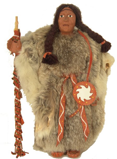 Plains Doll: Beautiful, hand crafted, carved wooden doll with full rabbit skin regalia including robe, plus a lance, shield, etc; very good condition. 13-1/2" x 6" Late 1900s