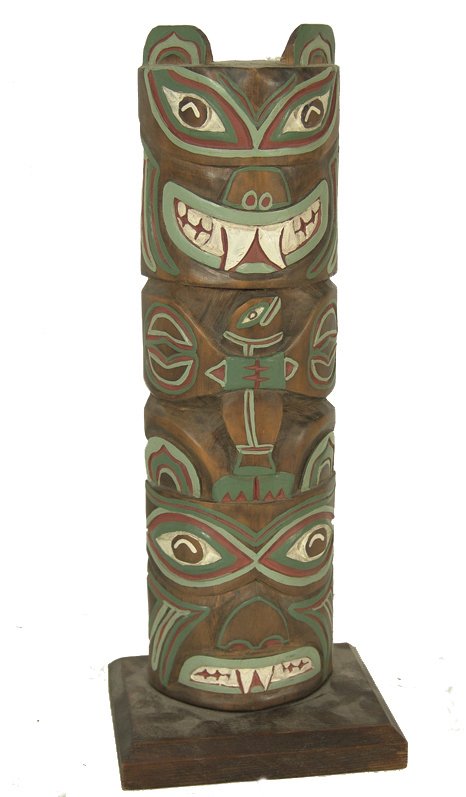 Northwest Coast Totem Pole: Beautiful two-figure (1 holding a salmon) hand carved tourist pole with red, white, and green painted accents. Condition: very good. 13" Circa: Mid 1900s