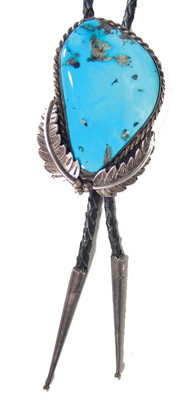 Navajo Bolo Tie: Classic, all-silver bolo tie with leaf accents set with a large bright blue Lone Mountain(?) turquoise stone. Condition: very good. 2-7/8" x 2" Circa: Ca. 1980s