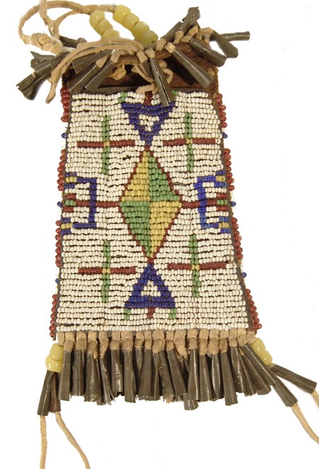 Sioux-Style Strike-a-Lite Case: Fine sinew sewn and lazy stitch beaded harness leather case with intricate design, tin cone suspensions, and flap. Condition: very good, some restoration and additions. 6" x 3" Circa: Mid 1900s