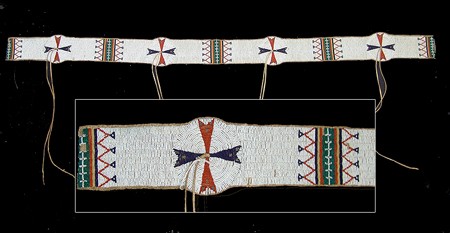 Sioux Blanket Strip: Beautiful sinew sewn and lazy stitch beaded strip done on buckskin with interesting geometric designs and round rosettes, each with a buckskin suspension. Condition: excellent. 60" x 4-1/4" Circa: Ear