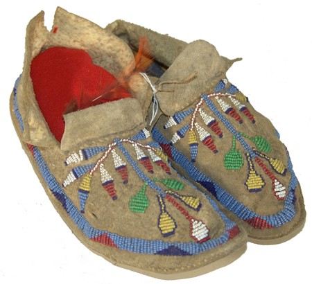 Sioux Beaded Moccasins: Classic pair of sinew sewn moose hide moccasins with painted parfleche soles and intricate beaded floral motif. Condition: very good. 8" Circa: Ca. 1900