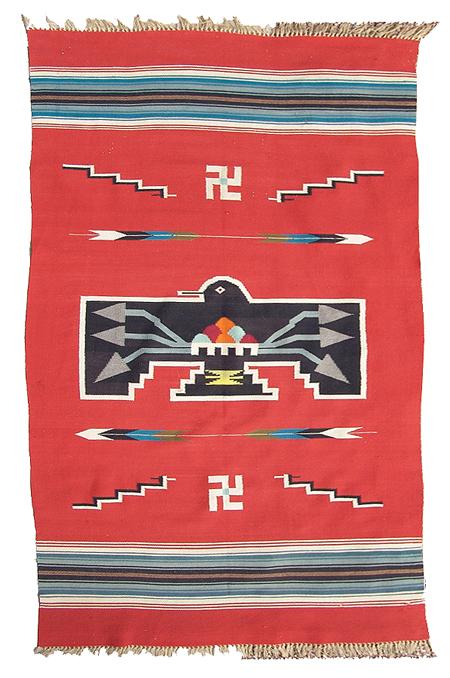 Vintage Chimayo Blanket: Classic hand woven woolen blanket with large central black thunderbird against red field; rain clouds and lightning appear on his chest, arrows, lighting, and whirling logs float in a field. Appraisal