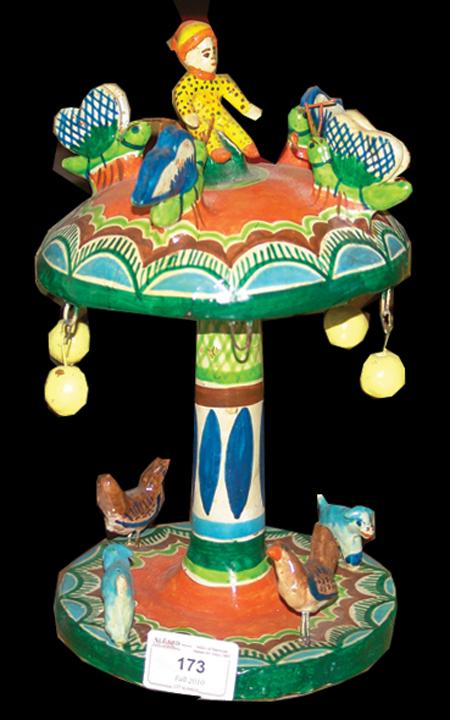 Mexican Pottery Figure: Colorful whirligig from Santa Cruz, Jalisco. Attributed to Oscar Ortega's father. Circa: 1960 Size: 6" x 11"