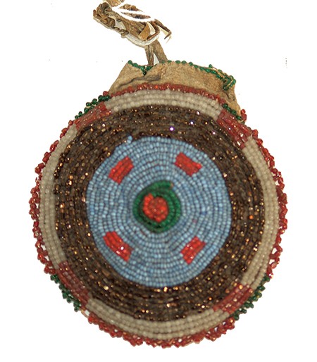 Crow Seed Pouch: Rare round shaped buckskin bag with fully beaded front and drawstring opening. Condition: very good. Size: 3-1/2" Circa: Early 1900s