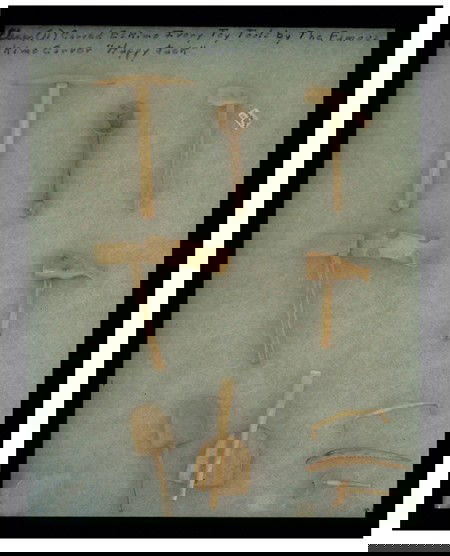 Miniature Eskimo Bone Tools: Framed collection of hand tools; shovel, pick, 3 axes, mallet, drawknife, saw, etc. Carved by famous carver Happy Jack. Size: Largest 4-1/4" Circa: 1980s