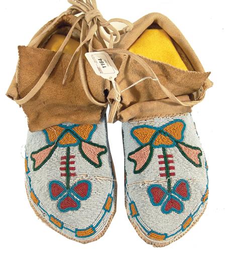 Cree Moccasins: Beautiful pair of men's beaded moccasins with flowing florals on a light blue field. Condition: very good, a few beads missing. Size: 11" Circa: Mid 1900s