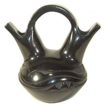 Santa Clara Jar- Cookie Tafoya: Beautiful deep carved blackware double necked wedding vase with unique squared edges and traditional Avenyu design. Very good condition. Circa: 1980s Size: 8-1/2" x 8-1/2"