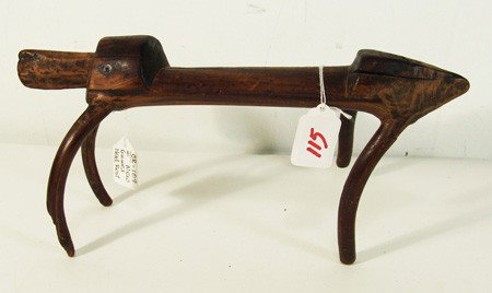 New Guinea Headrest: Rare intact carved ironwood headrest in the form of a lizard. Good condition, 1 repair. Circa: Mid 1900s Size: 7" x 14"