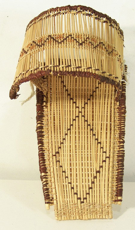 Paiute Toy Cradle: Traditional style woven basketry cradleboard with typical sun shade and redfern edging. Very good condition. Circa: Mid 1900s Size: 11" x 6"
