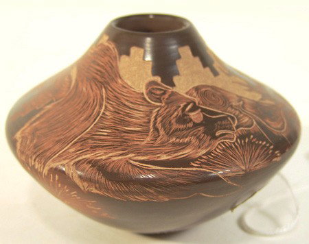 Santa Clara Seed Pot- Juan Tafoya: Superfine brown ware seed pot with highly detailed sgraffitto work depicting a grizzly bear and foliage. Very good condition. Circa: Late 1900s Size: 3" x 4"