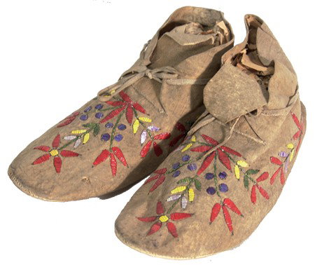 Santee Sioux Quilled Moccasins: Outstanding pair of hard soled sinew sewn moccasins with fine flowing quilled floral designs. Very good condition, very few missing quills. Circa: Early 1900s Size: 11"