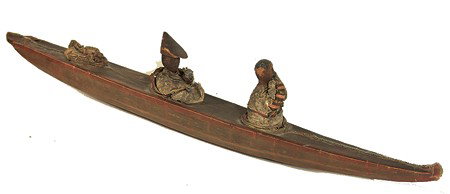 Eskimo Toy Kayak: Very rare early hand crafted whale gut and wood 3 hole boat with waist spray skirts, carved wooden heads (on the 2 dolls), and excellent patina. Good used condition. Circa: Early 1900s Size: 4-1/2" x 