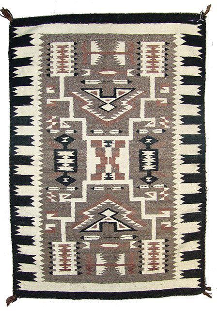 Navajo Rug/Weaving: Traditional storm pattern rug made from homespun wools with feather and other intricate geometric forms on a rare heather field. Very good condition. Circa: 1960 Size: 42" x 60"